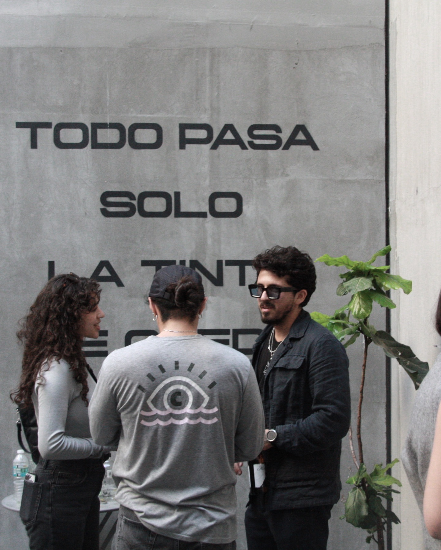 Group gathered in front of a mural near the studio